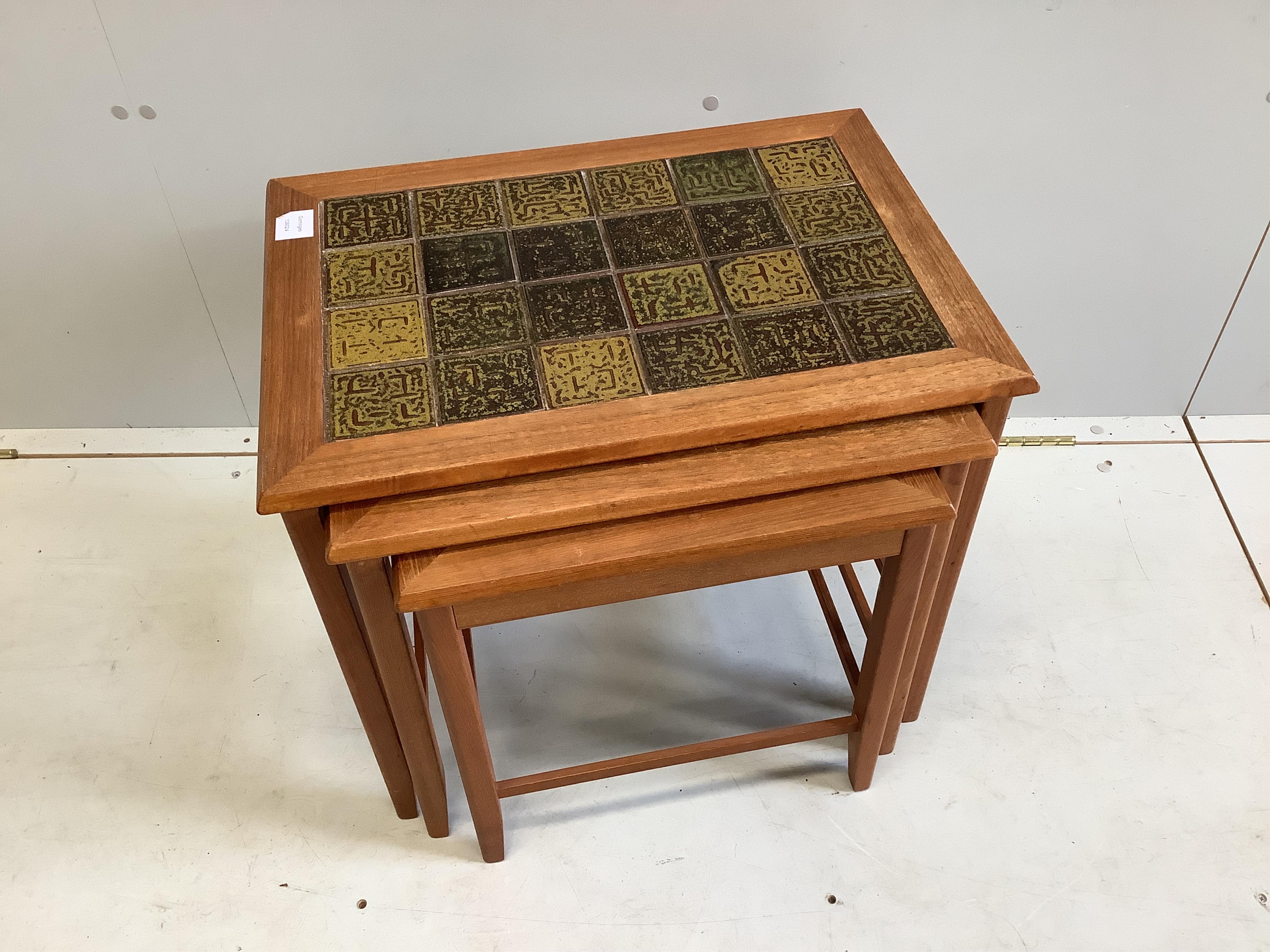 Trioh, a nest of three mid century Danish teak tile top tea tables, width 56cm, depth 41cm, height 48cm